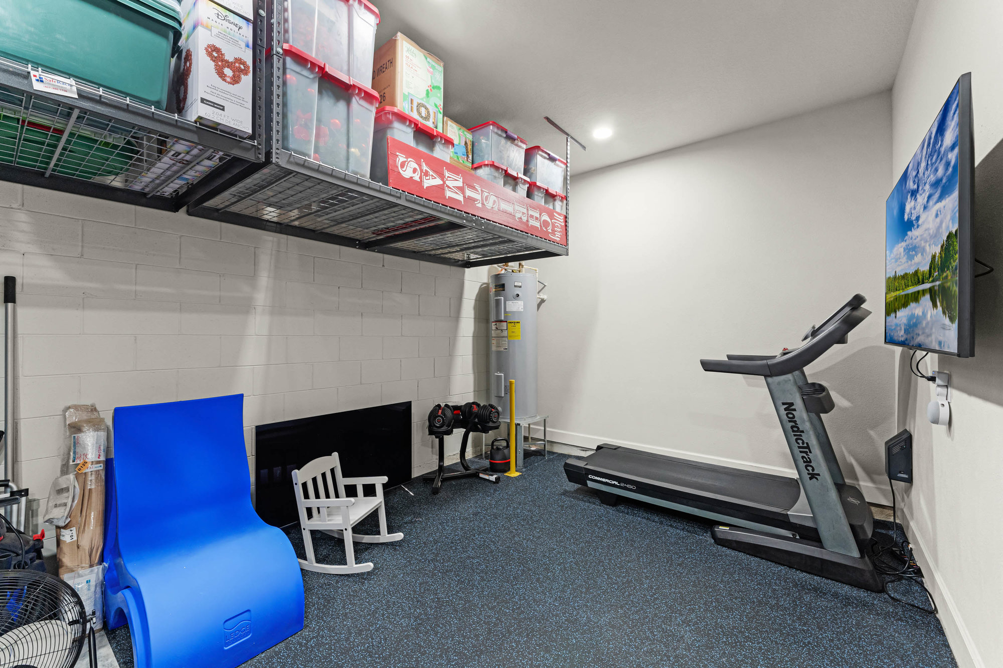 home gym and storage room with treadmill and shelves